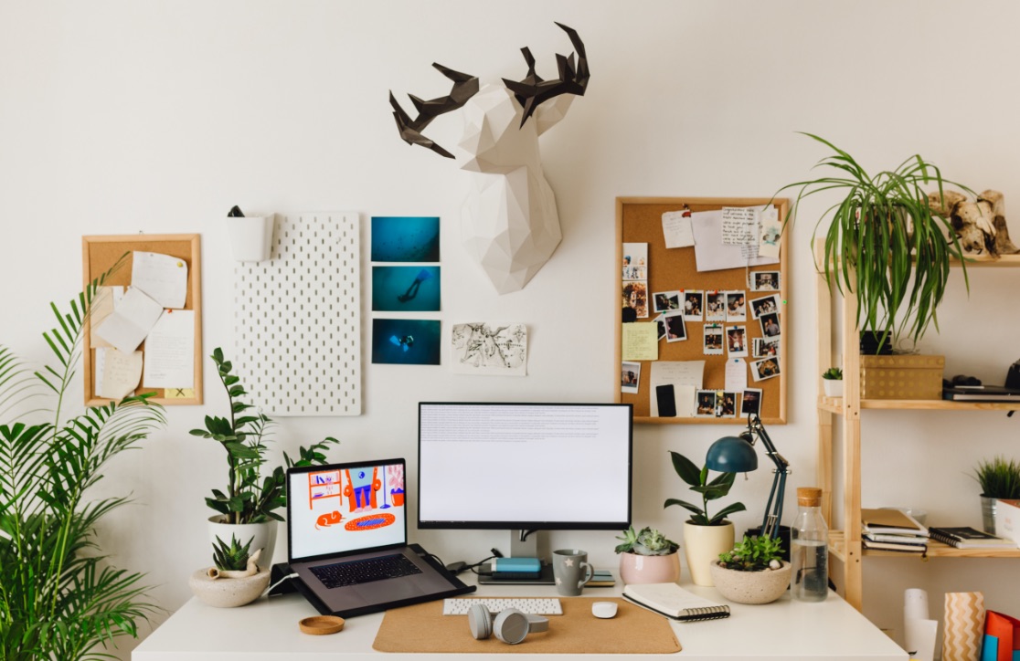 Vibrant desk with computer, laptop, and decor