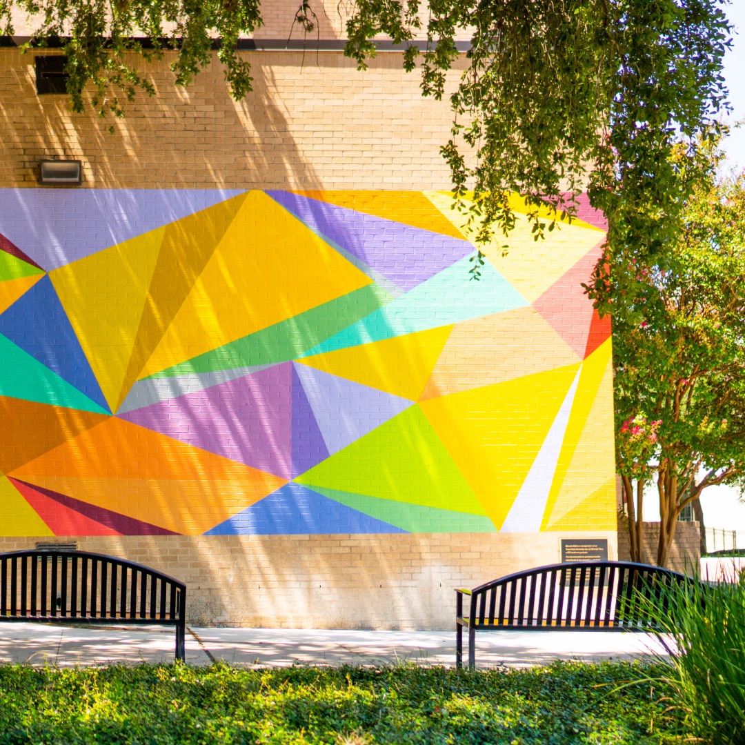 Geometric mural on outdoor brick wall